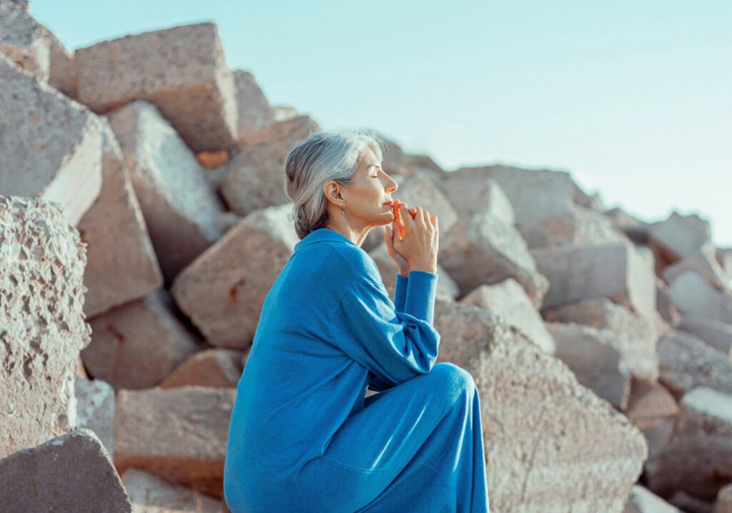 Calm woman sitting on the rocks